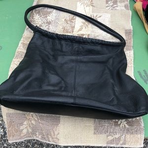The Sak black leather hobo bag with snap closure